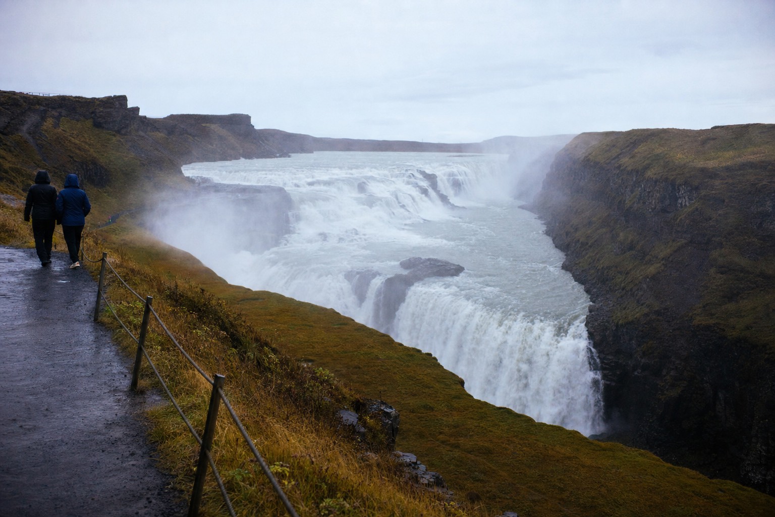Early morning spray rising over Gullfoss waterfall before the first coaches arrive